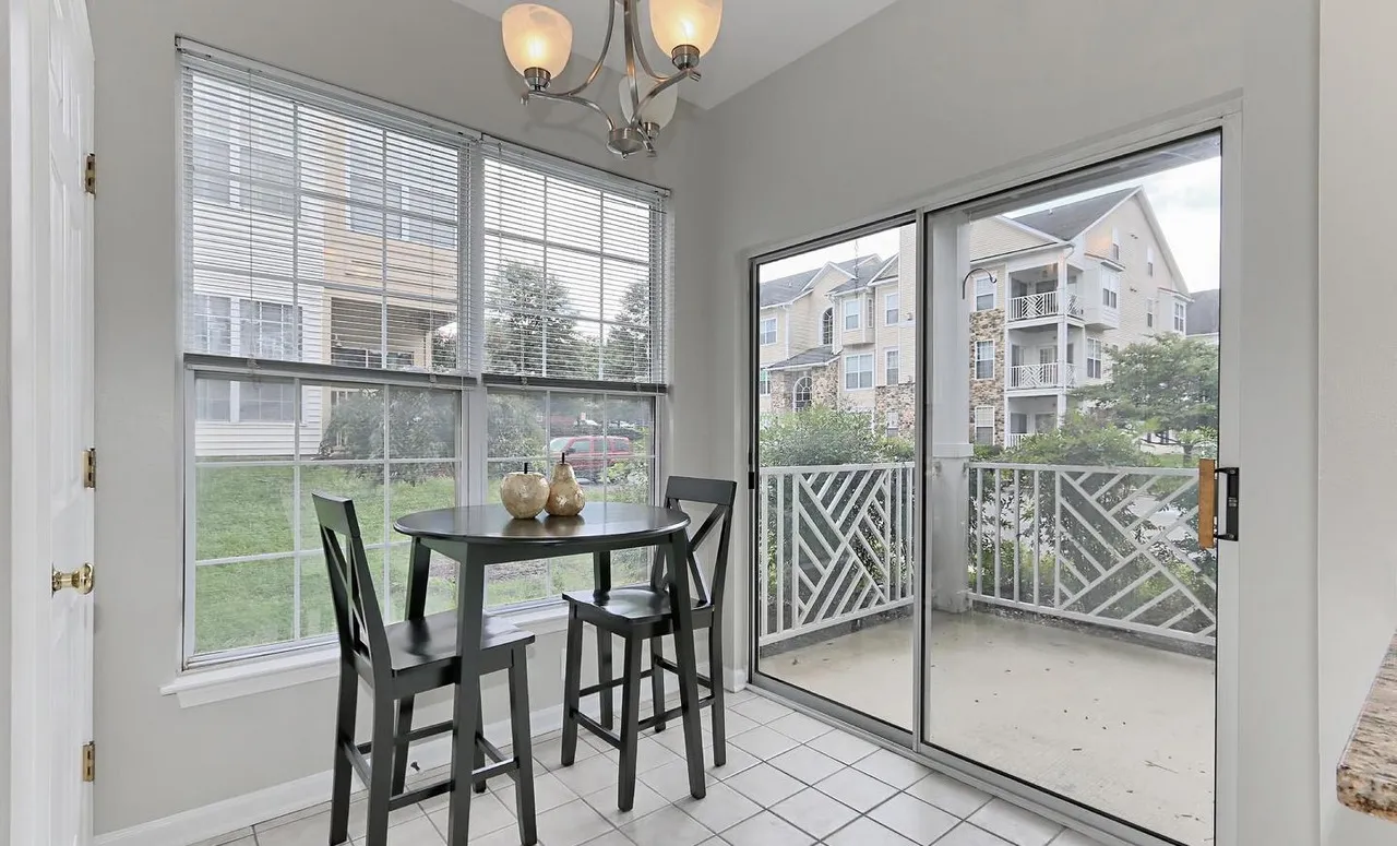 Dining nook beside sliding doors to a balcony.